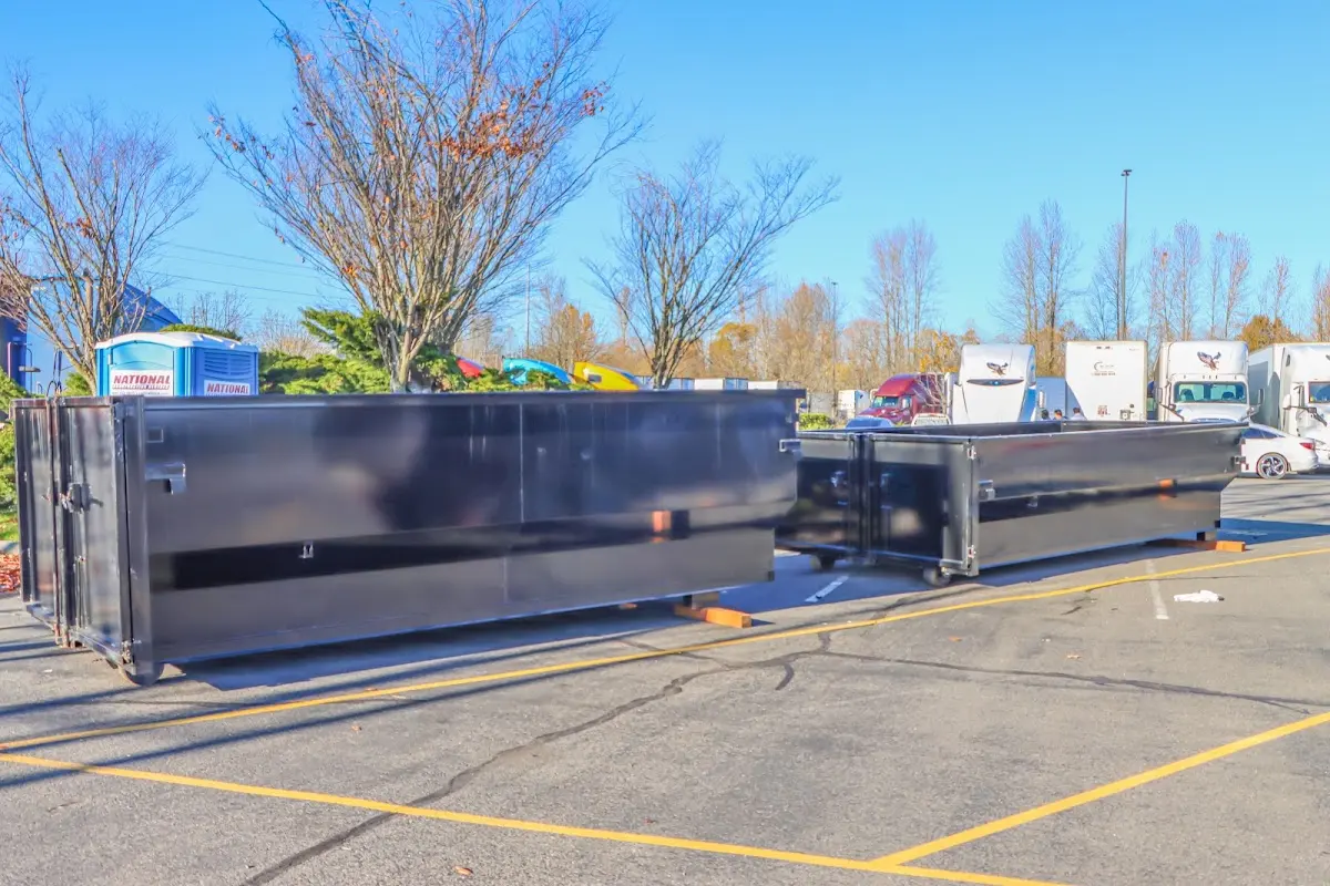 Professional dumpster rental service with roll-off container on residential driveway in Valencia West